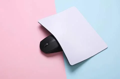Computer mouse under blank paper on pastel background Stock Photos