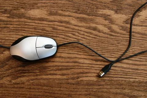 Computer mouse on wooden surface Stock Photos