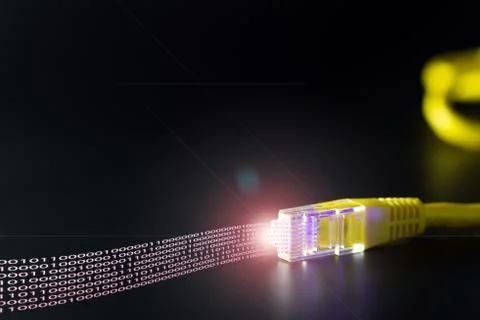 Computer network cable displaying binary data on black background Foto stock