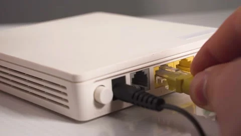 Computer network cable inserts in lAN router port Stock Footage 237539974
