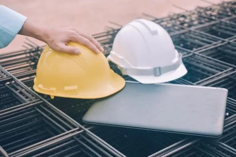 Computer note book Yellow helmet and Whit helmet on steel building constructi Stock Photos