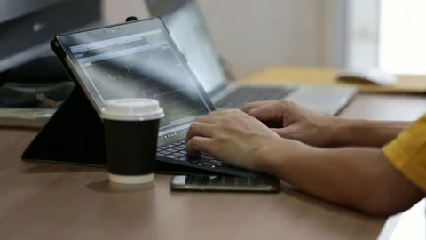 Computer notebook and stock trading on screen with businessman in casual Video stock 80749098