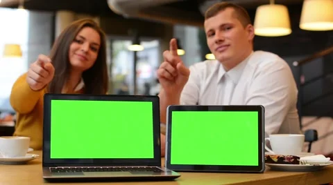 Computer (notebook) and tablet green screen - happy couple smiles to camera 動画素材 44737873