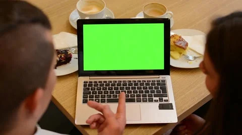 Computer (notebook) green screen - woman and man works on computer in cafe Stock Footage 44732800