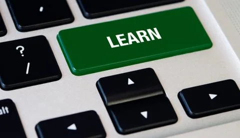 Computer notebook keyboard with Learn green key, silver laptop Stock Photos