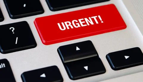 Computer notebook keyboard with Urgent red key, silver laptop Stock Photos