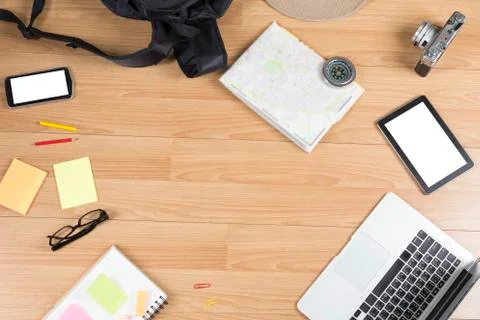 Computer notebook, notepad and map on wooden table Stock Photos