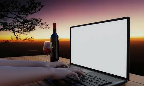 A computer or laptop with a blank screen on a wooden table with a glass of .. 스톡 사진