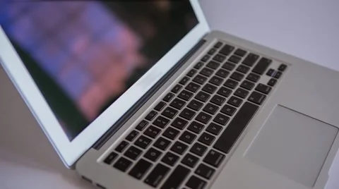 Computer pan across keyboard reflecting windows Stock Footage 40100687