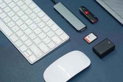 Computer peripherals and digital storage accessories on a workspace desk Stock Photos