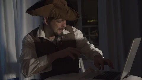 A computer pirate sitting at the laptop funny concept of digital security Stock Footage 121343114