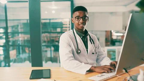 Computer, portrait and typing with doctor black man at desk in hospital for.. Stock Photos