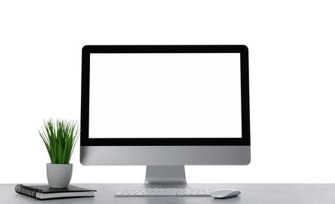 Computer, potted plant and notebook on table against white background. Styl.. 스톡 사진