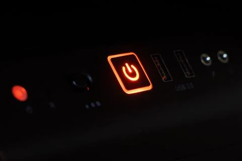 Computer power button glowing in the dark Stock Photos