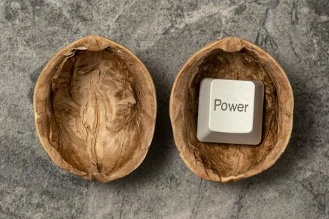 Computer POWER button inside cracked walnut shell Stock Photos