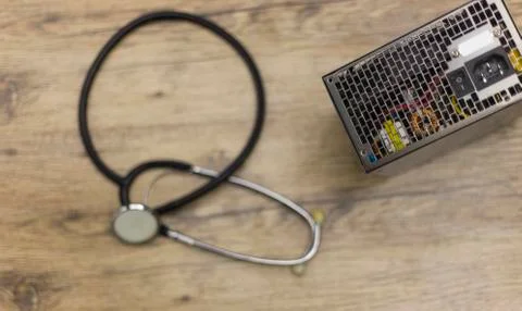 Computer power suply representing a phonendoscope health and wellness. Stock Photos