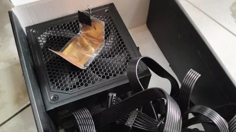 Computer power supply unit with cooling fan and black cables inside box Stock Footage 348708996
