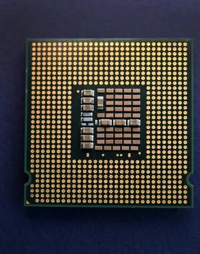 A computer processor on a blue background. Contacts on the processor case. 写真素材