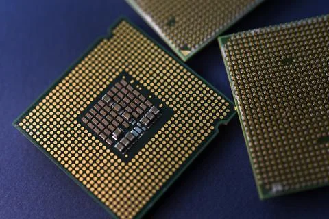 A computer processor on a blue background. Contacts on the processor case. 写真素材