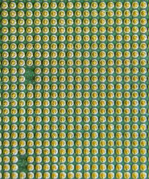 Computer processor, contact feet. Electronic board with electrical components Stock Photos