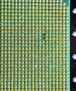 Computer processor, contact feet. Electronic board with electrical components Stock Photos