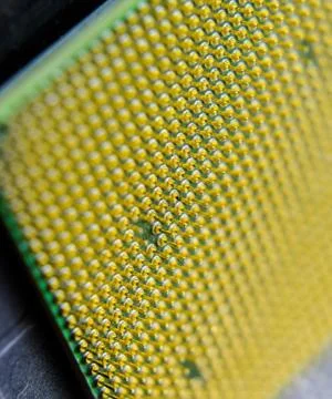 Computer processor, contact feet. Electronic board with electrical components Stock Photos