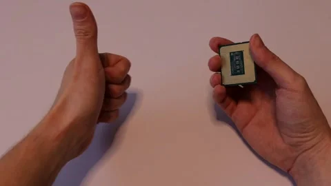 A computer processor (cpu) examined in hand and getting a thumps-up. Stock Footage 293059436