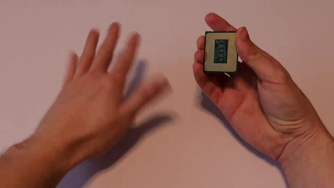 A computer processor (cpu) examined in hand. Stock Footage 293059445