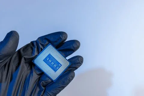 Computer processor in a gloved hand on a white background Foto stock