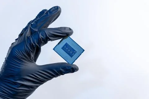 Computer processor in a gloved hand on a white background 스톡 사진