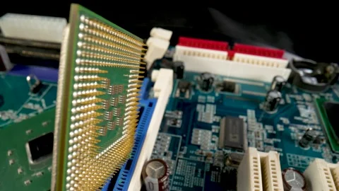 Computer processor rotating on motherboard circuit background with electronic Stock Footage 182405430
