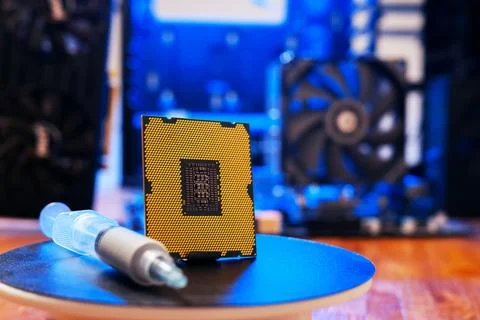 Computer processor with thermal paste close up. Modern computer part with PC 库存照片