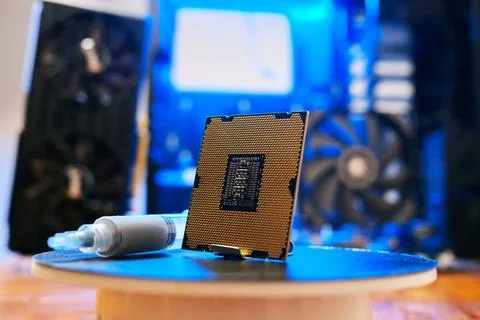 Computer processor with thermal paste close up. Modern computer part with PC Stock Photos