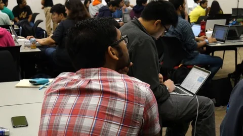 Computer Programers preparing to build software at a Hackathon Conference Stock Footage 93171327