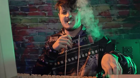 Computer Programmer From 1980's Lighting Cigarette In Front of Desktop PC Stock Footage 297874855