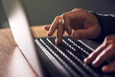 Computer programmer and hacker hands typing laptop keyboard Stock Photos