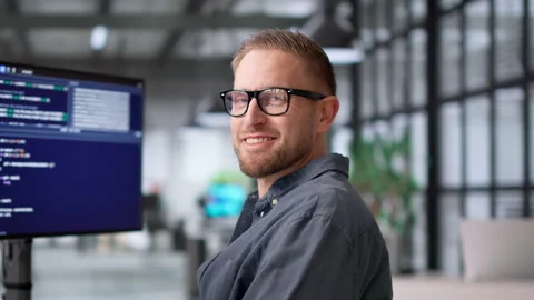 Computer Programmer Happily Writes Software Code Using Multiple Monitors Video stock 331517234