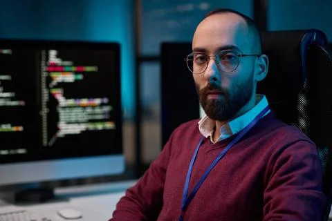 Computer Programmer Looking at Camera with Code Lines 스톡 사진