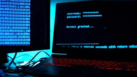 A computer programmer or hacker prints a code on a laptop keyboard to break i Stock Footage 113623779