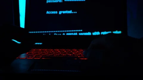 A computer programmer or hacker prints a code on a laptop keyboard to break i Stock Footage 113623826