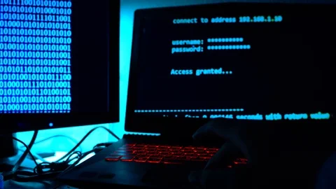 A computer programmer or hacker prints a code on a laptop keyboard to break i Stock Footage 113623834