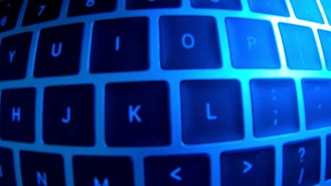A computer programmer or hacker prints a code on a laptop keyboard to break i Stock Footage 117591695