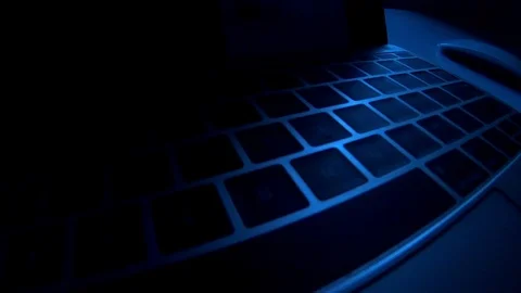 A computer programmer or hacker prints a code on a laptop keyboard to break i Stock Footage 117591788