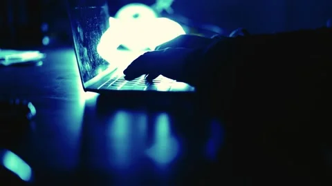 A computer programmer or hacker prints a code on a laptop keyboard to break i Stock Footage 138948909
