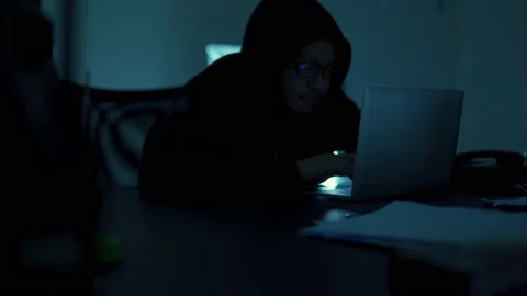 A computer programmer or hacker prints a code on a laptop keyboard to break i Stock Footage 138948910