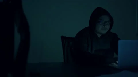 A computer programmer or hacker prints a code on a laptop keyboard to break i Stock Footage 138948931