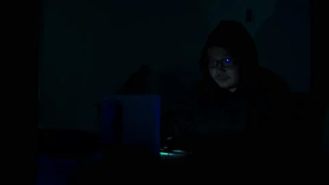 A computer programmer or hacker prints a code on a laptop keyboard to break i Stock Footage 138948974
