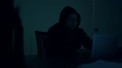 A computer programmer or hacker prints a code on a laptop keyboard to break i Stock Footage 138948983