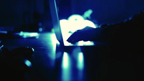 A computer programmer or hacker prints a code on a laptop keyboard to break i Stock Footage 138949003