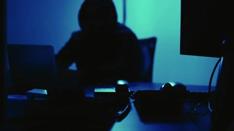 A computer programmer or hacker prints a code on a laptop keyboard to break i Stock Footage 138949328